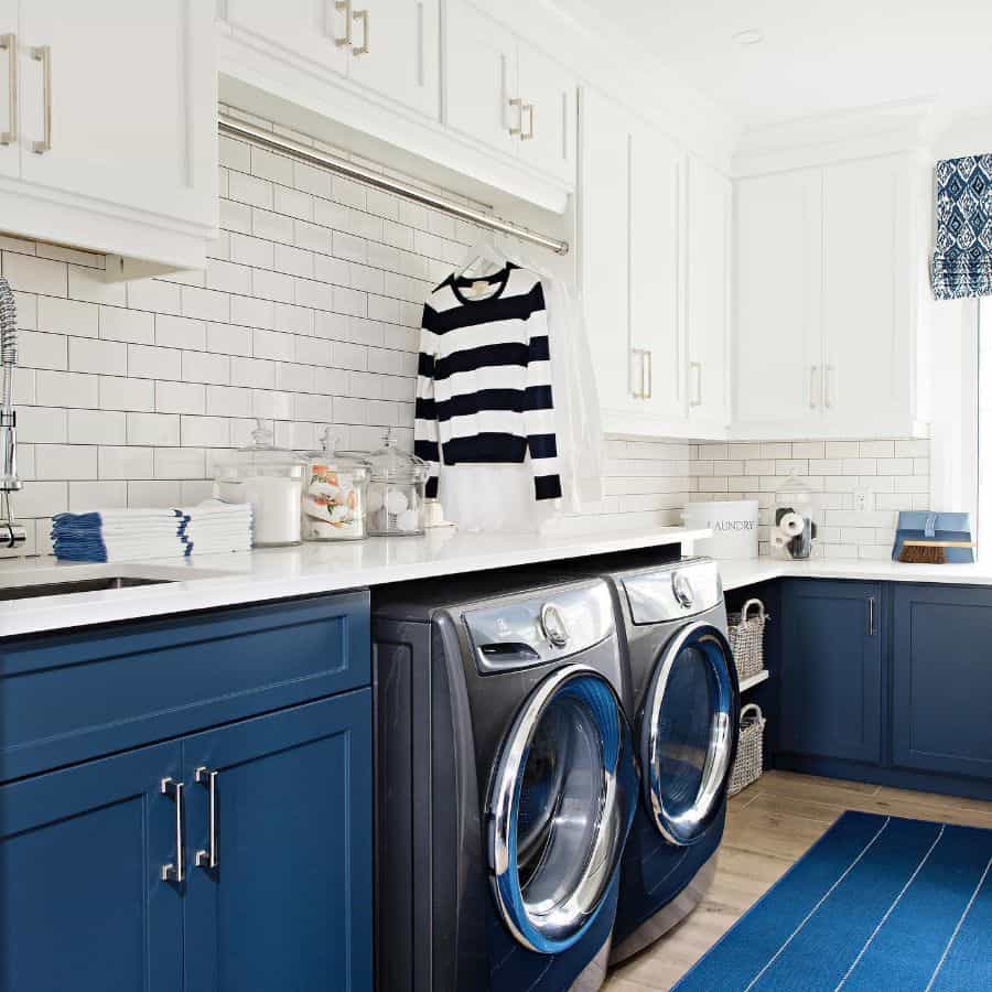 white and blue cabinet laundry white subway tile backsplash washer and dryer