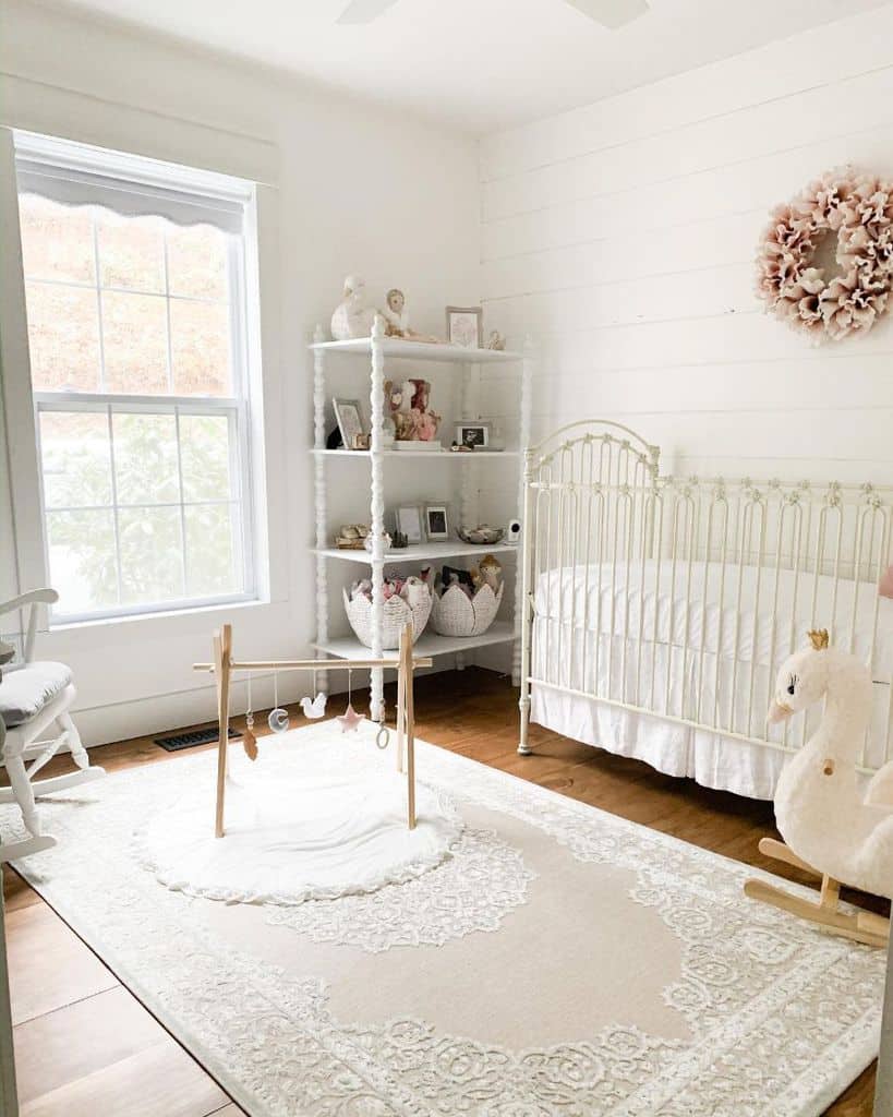 country style nursery shiplap walls white crib white shelving unit rocking duck toys 