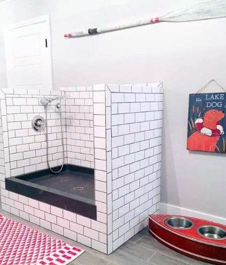 white subway tiles with black base floor home dog wash station oar wall art
