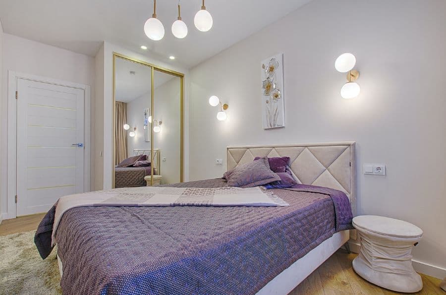 simple modern bedroom with purple duvet 