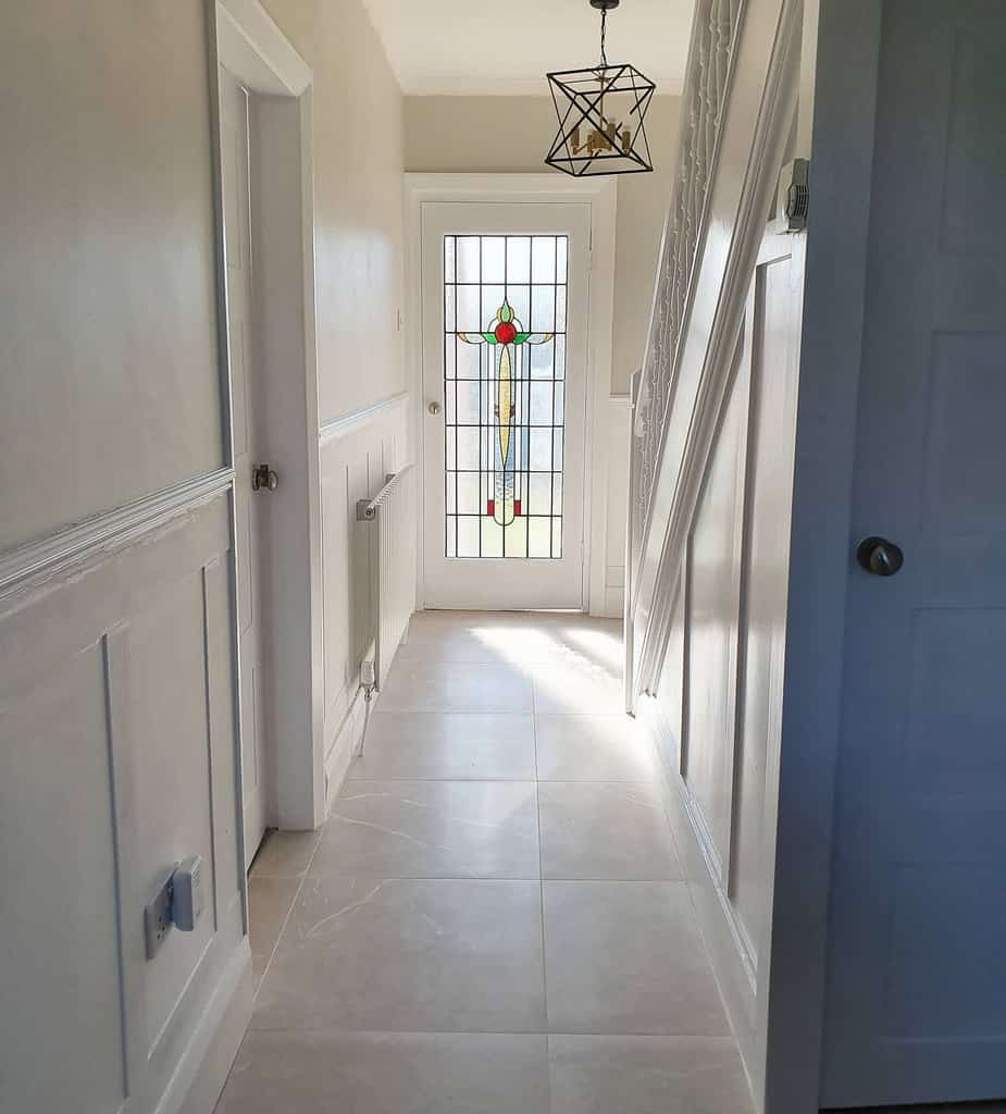white wall paneling hallway tile floor 