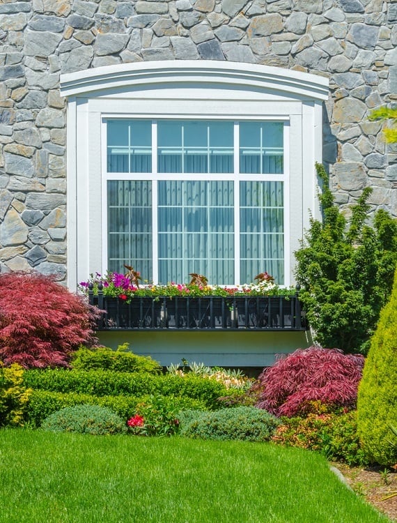 wide exterior window trim double and bay window stone wall