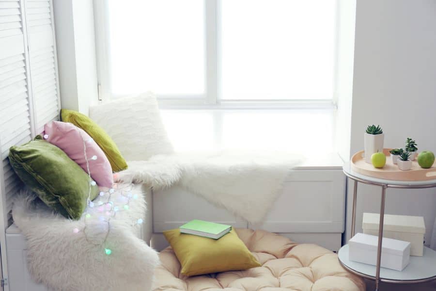 comfy window reading nook with fairy lights