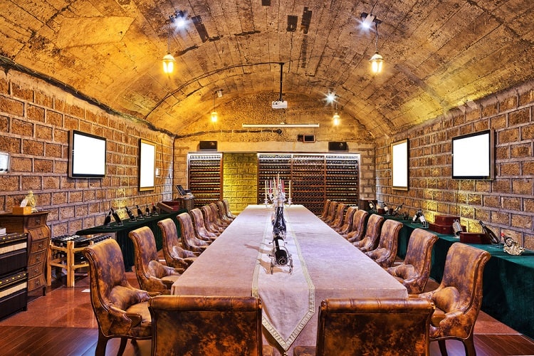 wine cellar vaulted ceiling long table wine racks