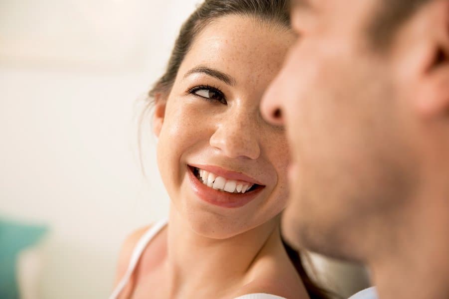 woman smiling while looking at his man