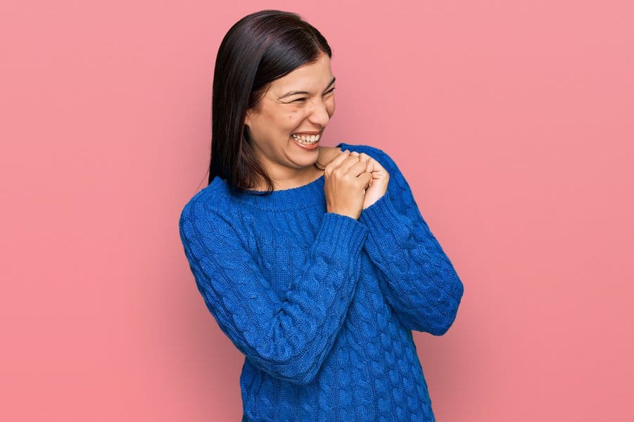woman wearing casual clothes laughing nervous 