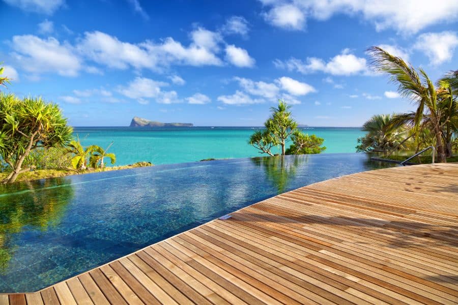 resort style wood deck with infinity pool