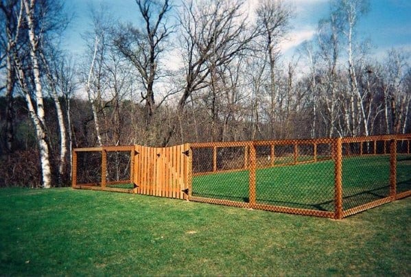 backyard wood and wire dog fence with wood gate