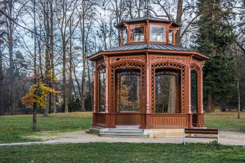 elaborate wooden gazebo public garden park bench 