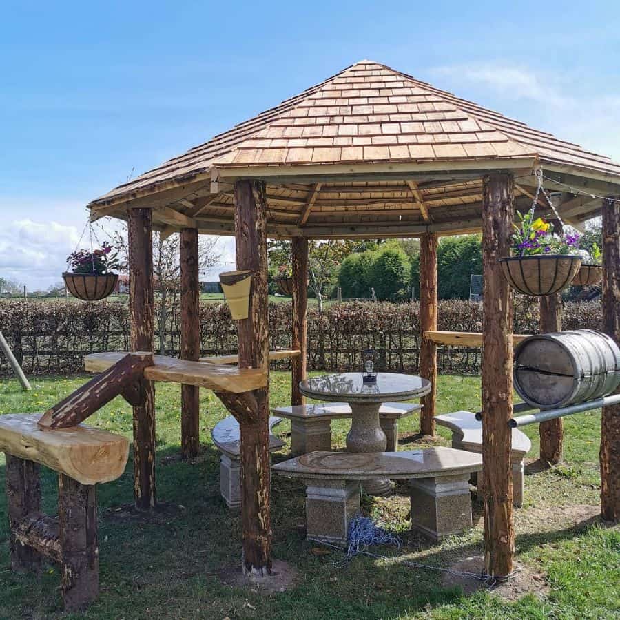 wooden gazebo granite table and bench seats 