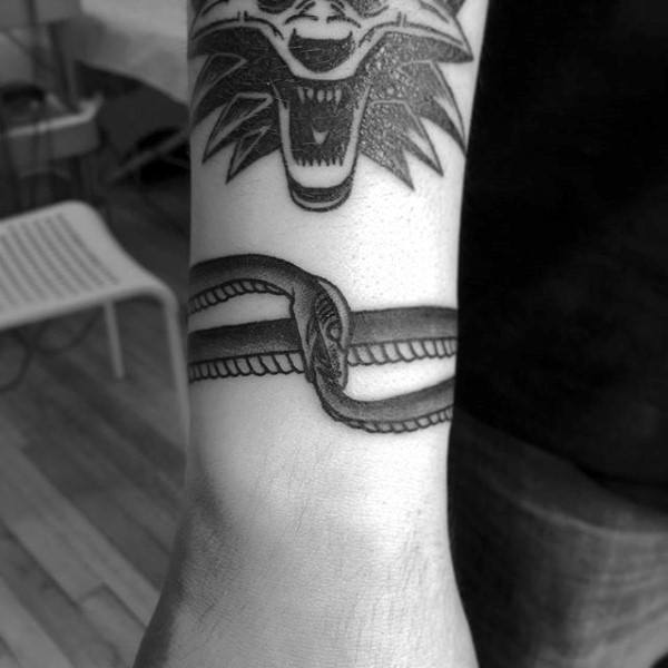 Wrist Band Tattoo Of Ouroboros On Man