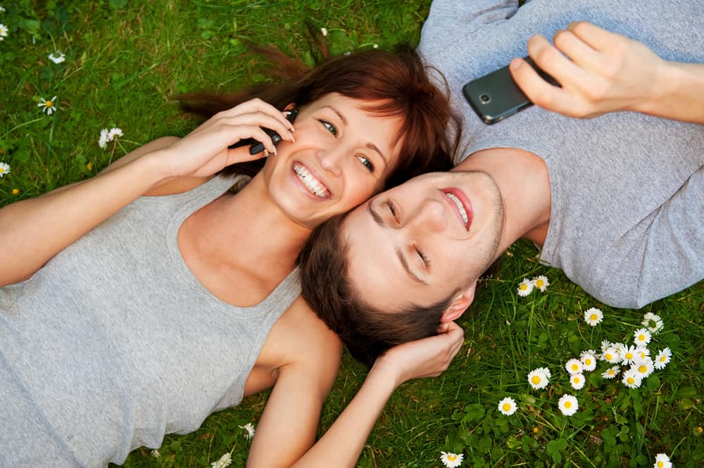 young-couple-using-mobile-phones