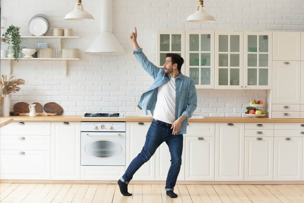 young man dancing in kitchen