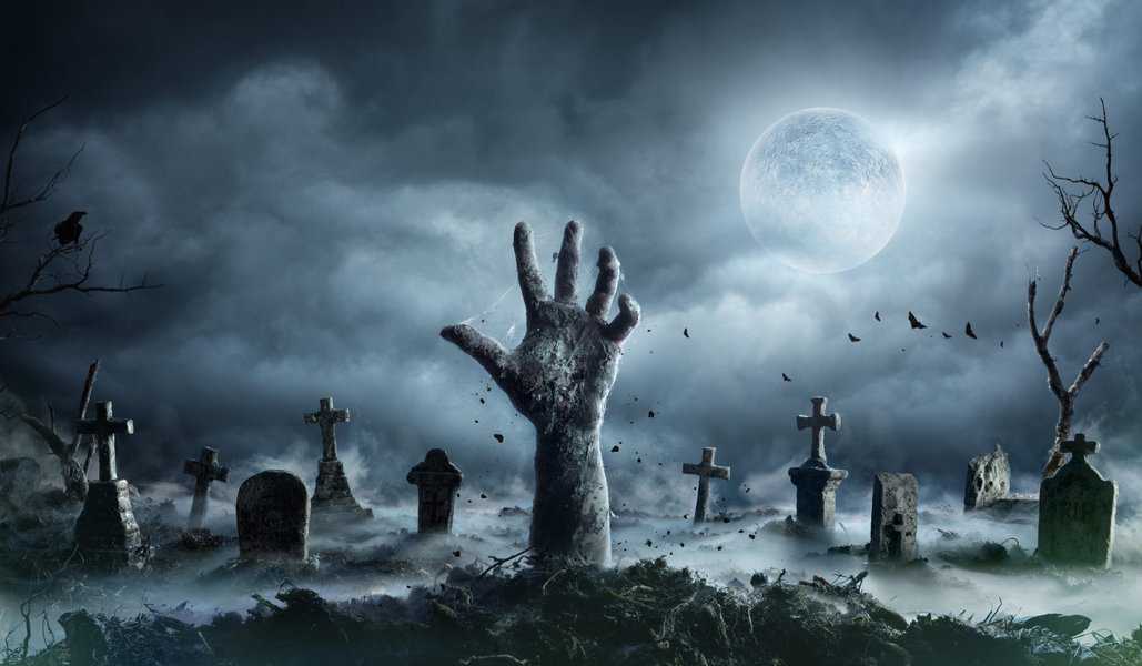 Zombie,Hand,Rising,Out,Of,A,Graveyard,In,Spooky,Night